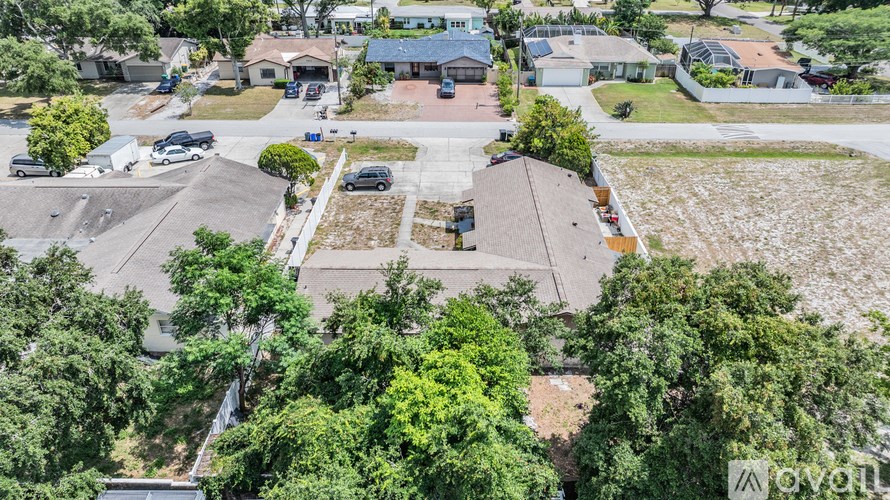 A bird's eye view of a residential area with houses and trees.