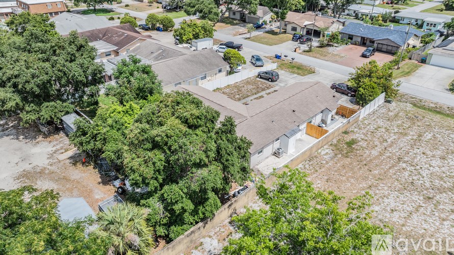A bird's eye view of a residential area with houses and cars.