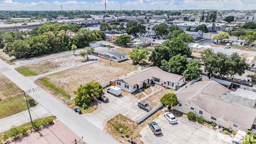 A parking lot with several cars and a building in the background.