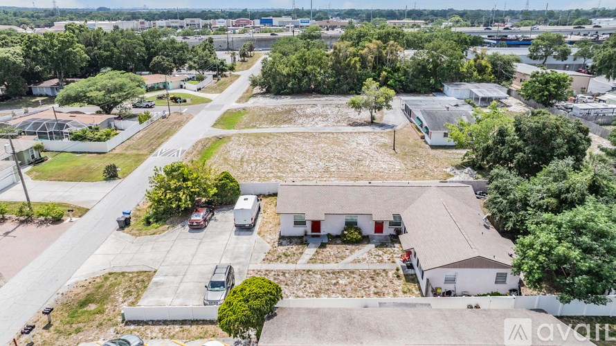 A large open area with a few buildings and vehicles.