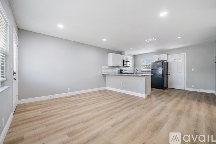 A kitchen with a refrigerator, microwave, and oven.