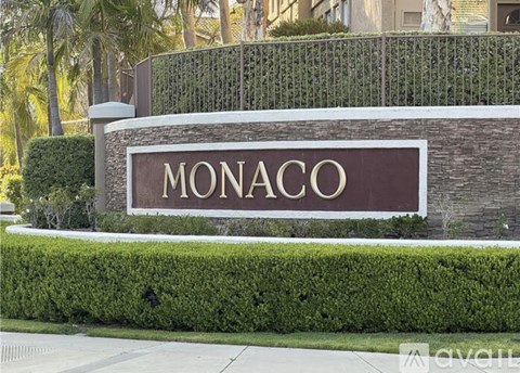 A sign that says Monaco in gold letters.