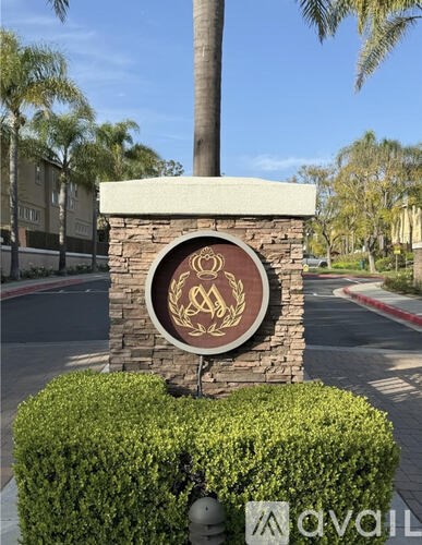 A sign with a symbol of a man and a woman is mounted on a stone pillar.