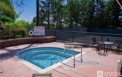 A pool with a table and chairs around it.