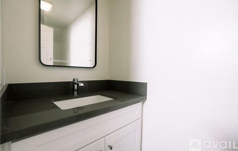 A bathroom sink with a mirror above it.
