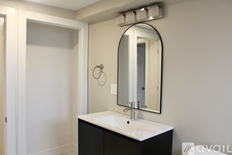 A bathroom with a sink and mirror.