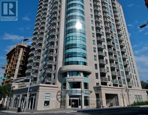 A tall building with a glass facade is the main focus of the image.