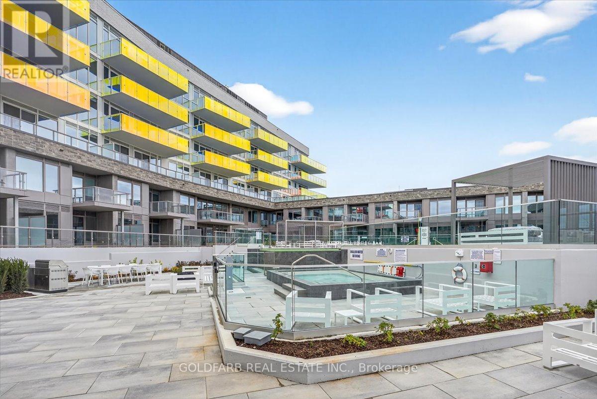 A modern building with a pool in the courtyard.