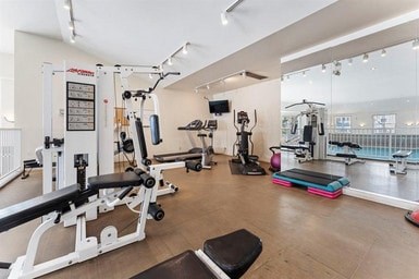 A gym with a variety of equipment including a leg press machine.