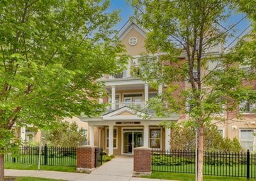 A house with a black fence in front of it.