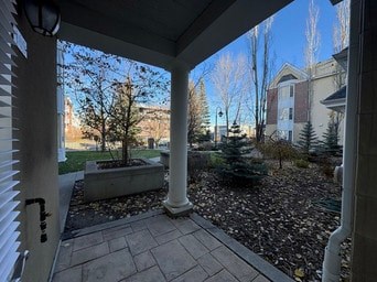 A view from a porch looking out at a landscaped yard.