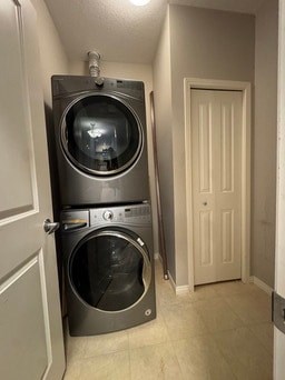 A washer and dryer stacked on top of each other in a small room.