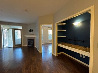 A room with a fireplace and a window.