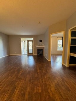 A room with wooden floors and a stove in it.