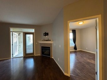 A living room with a fireplace and sliding glass doors.