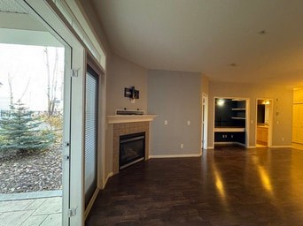 A room with a fireplace and a sliding glass door.