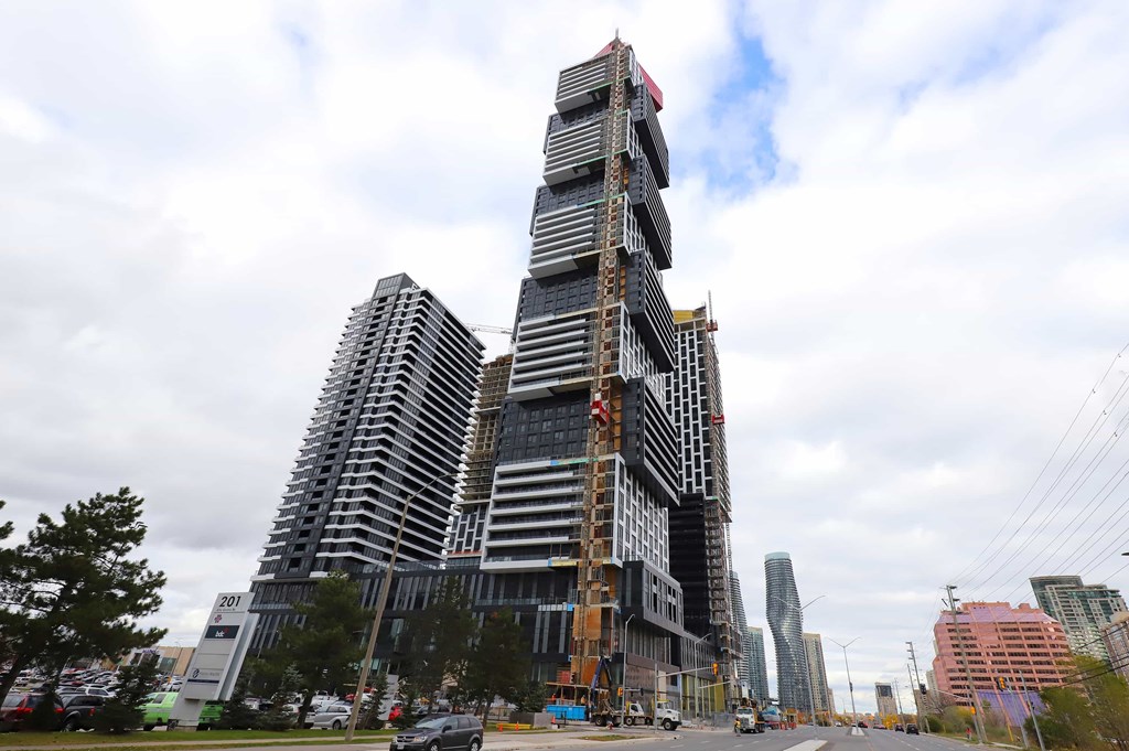 A large building under construction with a tall, narrow design.