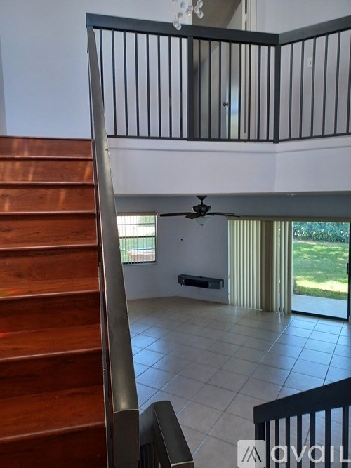 A chandelier hangs from the ceiling in a room with striped walls.