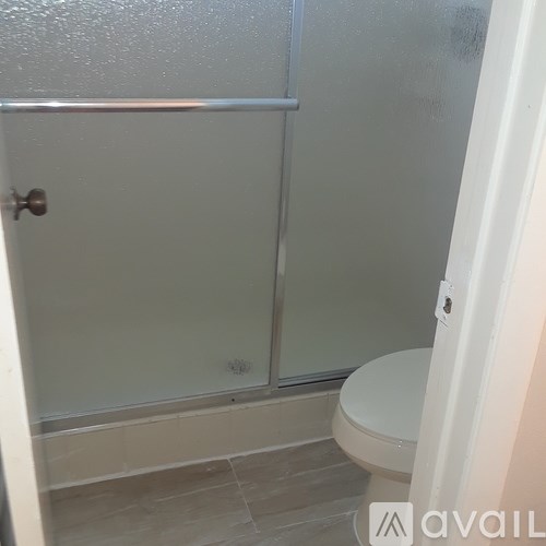 A small white toilet in a small bathroom.