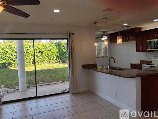 Two white washing machines in a small laundry room.