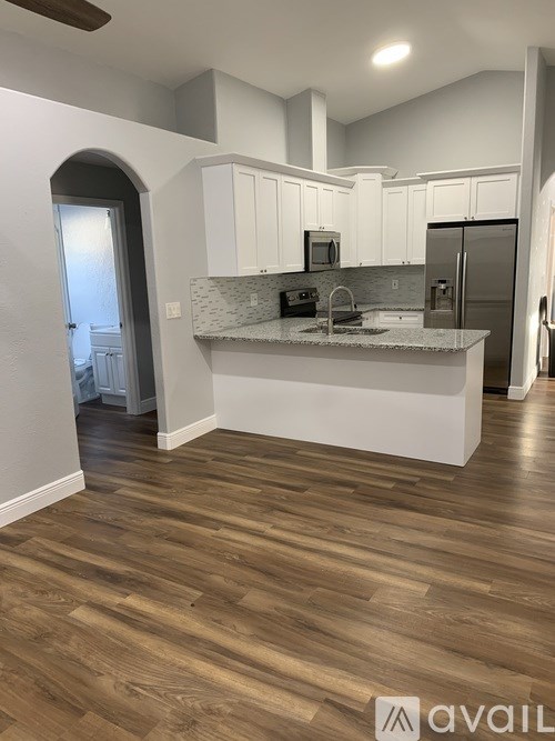 A kitchen with a countertop and a refrigerator.