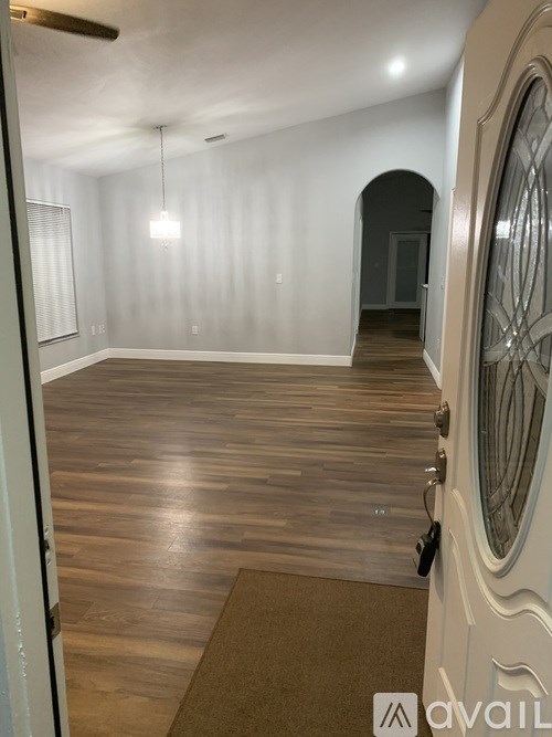 A room with wooden floors and a white door.