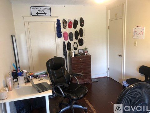 A room with a sign that says "Sidewalk Closed Ahead" on the wall.