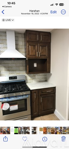 A kitchen with a stove and a hood.