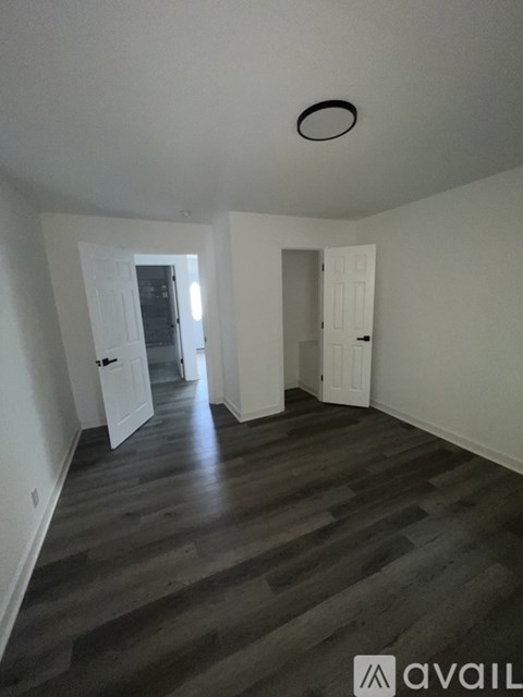 A room with wooden floors and white walls.