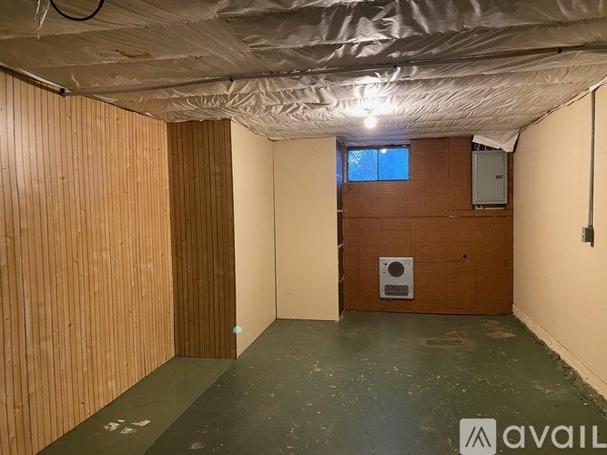 A room with wooden walls and a window.