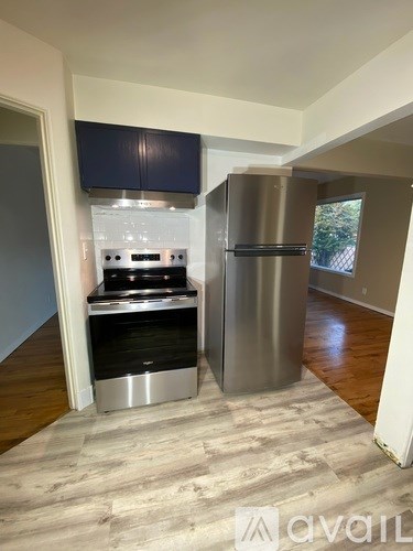 A kitchen with a stainless steel refrigerator and stove.