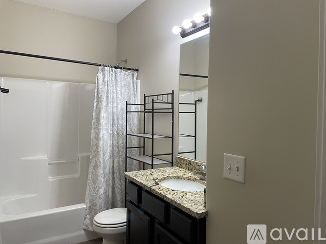 A bathroom with a sink, toilet, and bathtub.