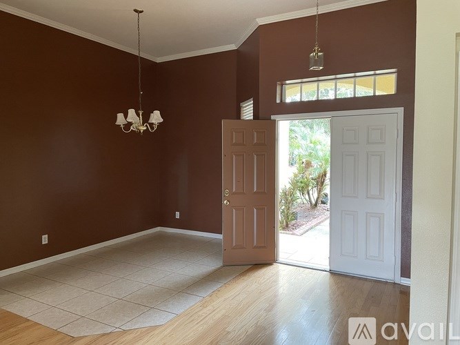 A room with brown walls and a white door.