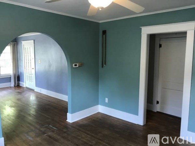 A room with a ceiling fan and a window.