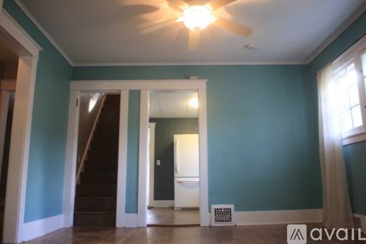 A room with blue walls and a ceiling fan.