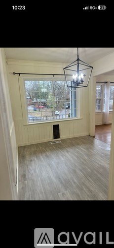 A room with a wooden floor and a large window.