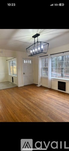 A room with wooden floors and a chandelier.