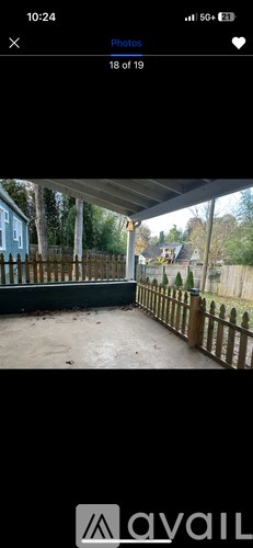 A wooden fence surrounds a concrete area.