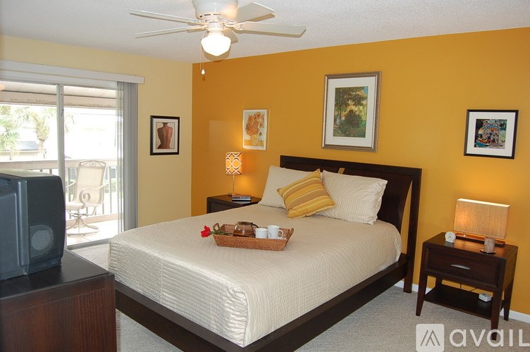 A bedroom with a bed, nightstand, and television.