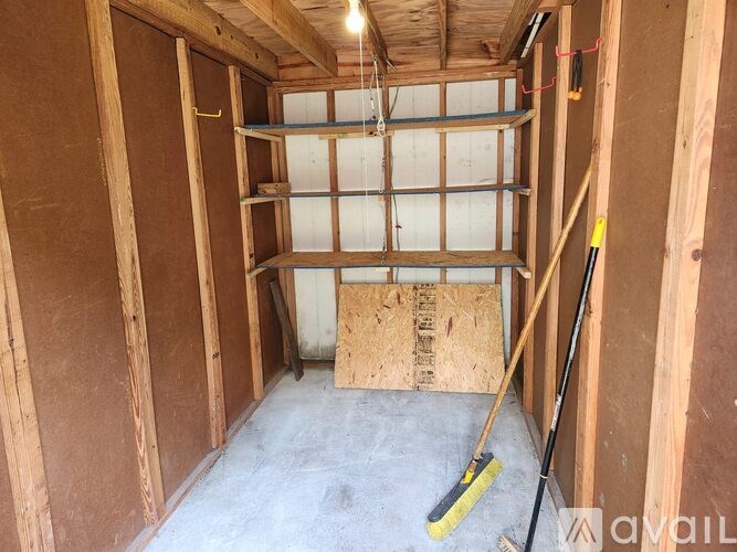 A room under construction with a mop on the floor.