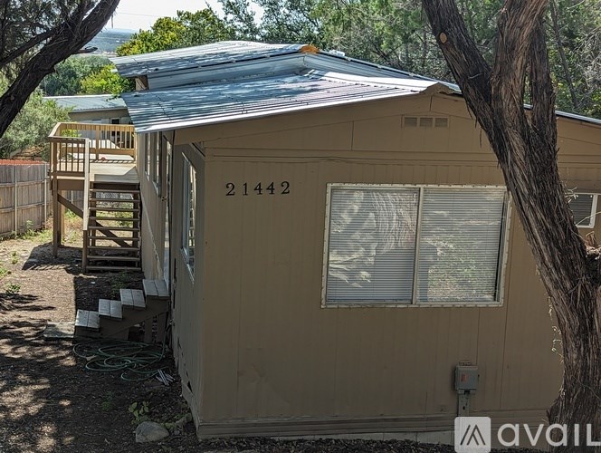 A beige house with the number 21442 on it.