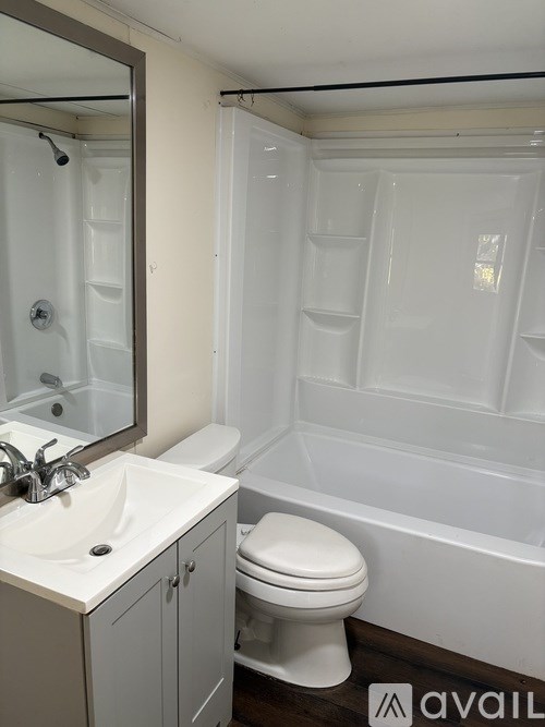 A white toilet sits next to a sink in a bathroom.