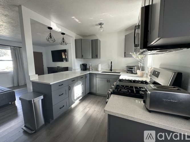 A modern kitchen with a stove top oven and a microwave.