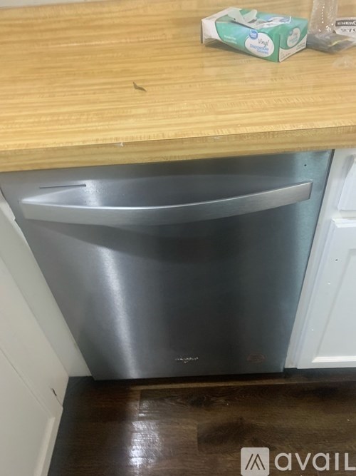 A stainless steel dishwasher is in a kitchen.