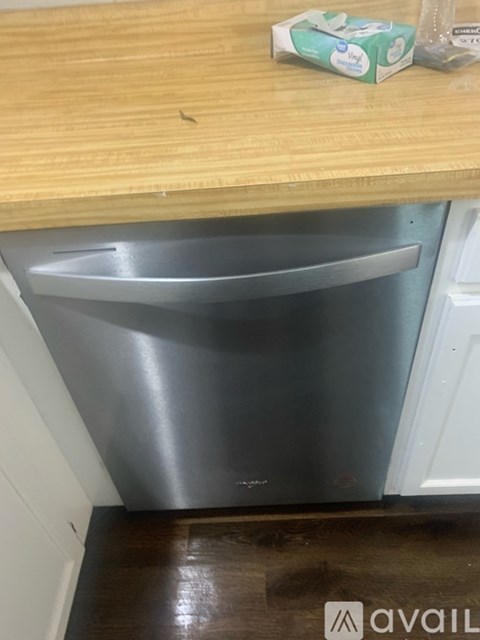 A stainless steel dishwasher is in a kitchen.