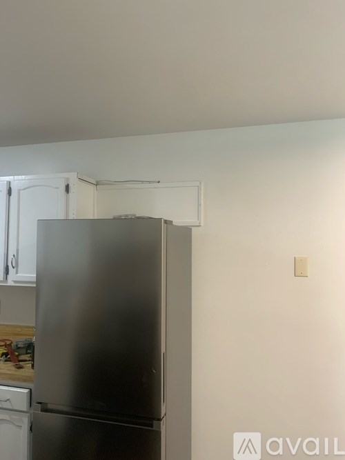A stainless steel refrigerator in a kitchen.