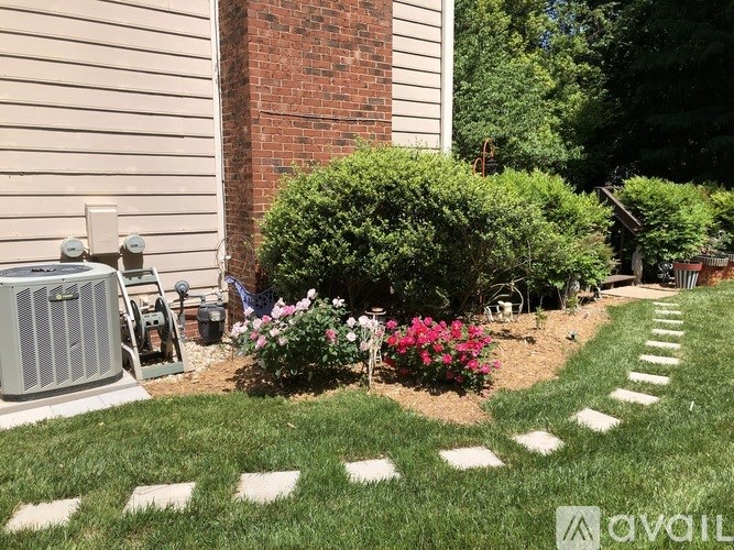 A garden with a brick wall and a green lawn.
