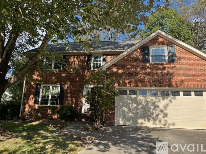A red brick house with a white garage door.