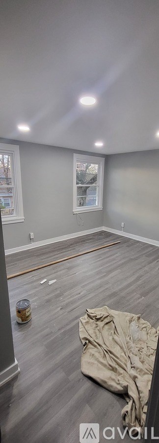 A room with grey walls and wooden flooring is shown.