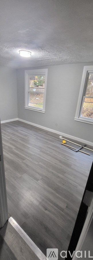 A room with a grey floor and a window.